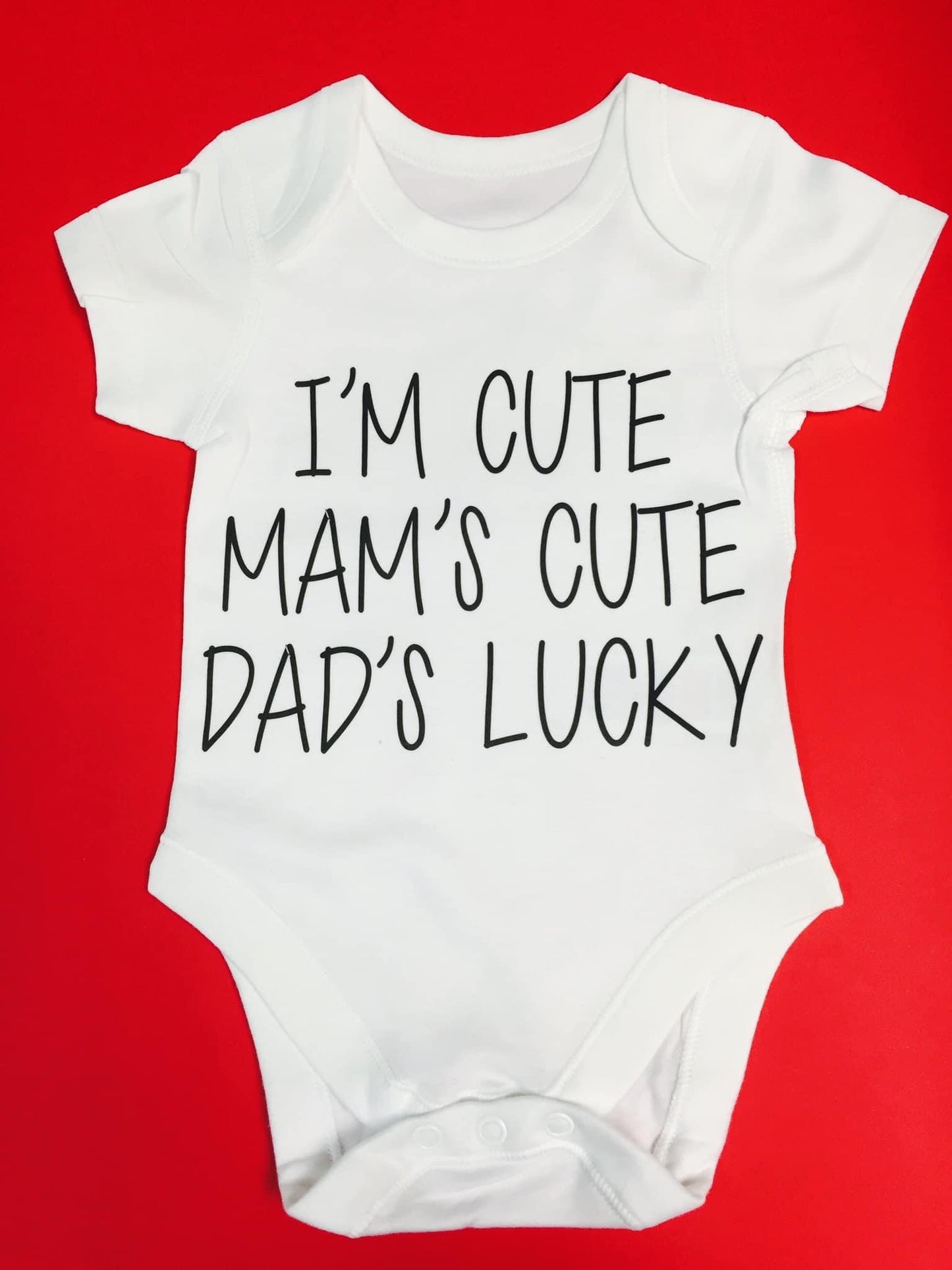 "I'm Cute. Mam's Cute. Dad's Lucky." Babygrow